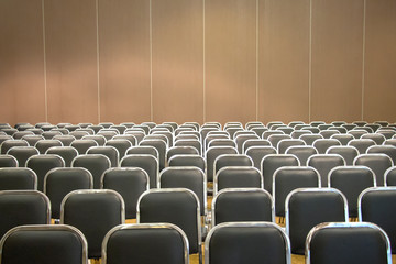 Fototapeta premium Black empty seats in the audience prepared for the participants of the conference or presentation. Organization and holding of mass events
