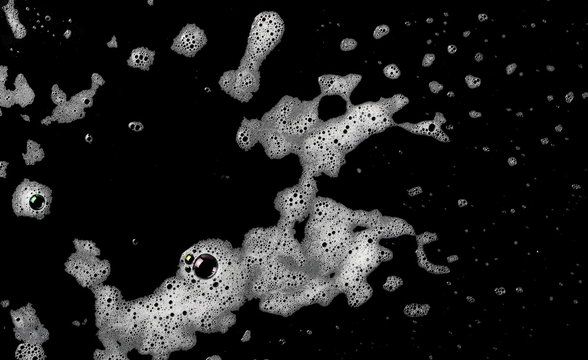 Soap foam isolated on black, with clipping path, texture and background, top view