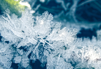 winter background with snowflakes crystals patterns and snow on frozen grass