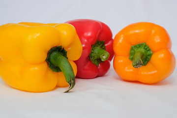 Variety of colorful red, green, yellow paprika bell peppers, tomatoes Healthy eating food