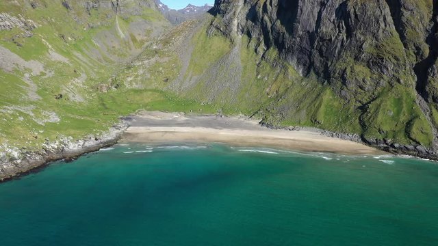 aerial view. flight over the sea,view on the wild beach Kvalvika.Camera move forward .Lofoten Islands,Norway