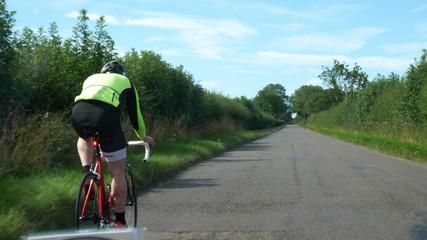 driver pov shot overtaking cyclist while driving on british countryside road in england