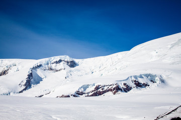 Fototapeta na wymiar Magnificent view of the snow-white tall mighty mountains Elbrus, ski resort, the Republic of Kabardino-Balkaria, Russia