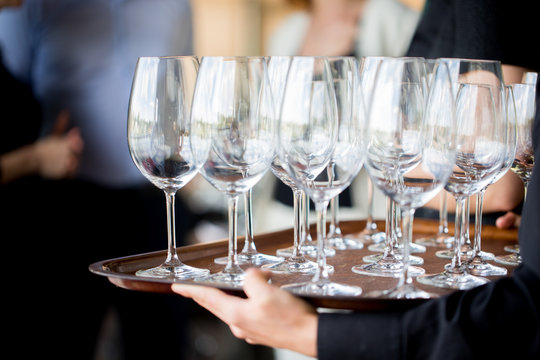 Waiter carrying glasses of wine on a tray