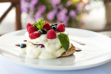 pancakes with blueberries, raspberries and cream