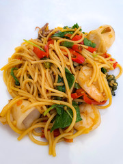 Stir fried spicy Spaghetti with sea food. Spaghetti fried with prawns, squid and vegetables.