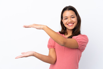 Young Colombian girl over isolated white background holding copyspace to insert an ad