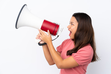 Young Colombian girl over isolated white background shouting through a megaphone