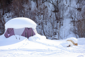 Snow-covered tent in winter in the park in the mountains Elbrus, ski resort, the Republic of Kabardino-Balkaria, Russia.