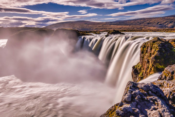 Goðafoss in long exposer, blue sky, warm autumn colors, Iceland