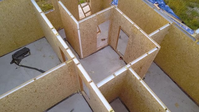 Construction of new and modern modular house. Walls made from composite wooden sip panels with styrofoam insulation inside. Building new frame of energy efficient home concept.