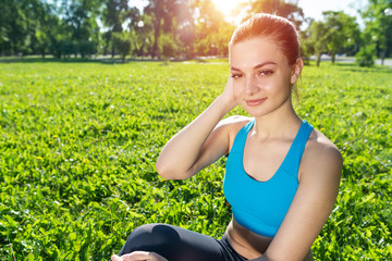 Beautiful smiling girl in sportswear relax in park