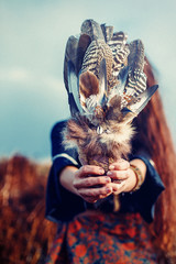 Shaman woman and shamanic feathers on denim.
