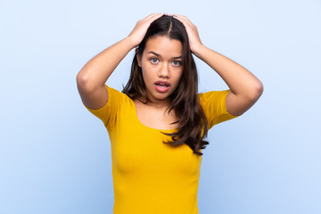 Fototapeta premium Young Colombian girl over isolated blue background with surprise facial expression