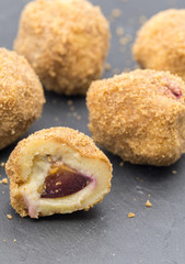 delicious dessert plum filled dumplings served on slate