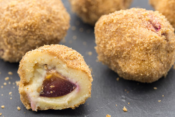 delicious dessert plum filled dumplings served on slate