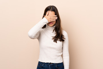 Young Colombian girl over isolated background covering eyes by hands. Do not want to see something