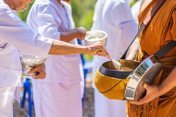Fototapeta premium The monks of the Buddhist Sangha(give alms to a Buddhist monk), which came out of the Buddhist offerings in the morning. In order to demonstrate faith faithfully perform the duties recently.