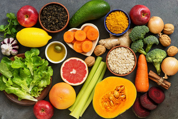 Liver detox diet food concept. Healthy nutrition for the liver, fruits,vegetables, nuts, olive oil, citrus fruits, green tea, turmeric, oats. Top view, flat lay.