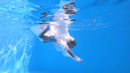 Jump into the water..Boy jumping into the water. Underwater shot.