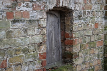 old wooden door in stone wall