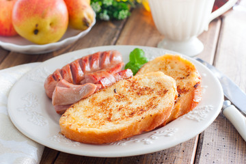 Toasted white bread on a plate on a wooden table, selective focus