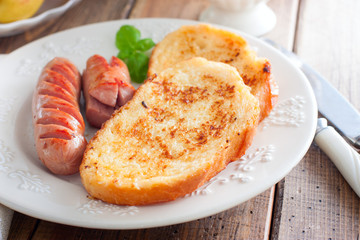 Toasted white bread on a plate on a wooden table, selective focus