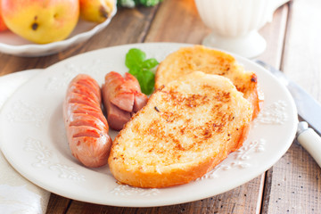 Toasted white bread on a plate on a wooden table, selective focus