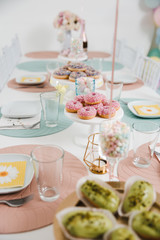 Food served on table in a white hall during a children Birthday party decoration in Eastern European Baltic Riga Latvia - Mild Biege, creme, pink colors - Canape, snacks and light drinks