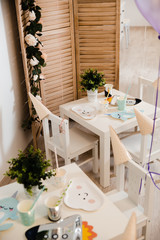 Food served on table in a white hall during a children Birthday party decoration in Eastern European Baltic Riga Latvia - Mild Biege, creme, pink colors - Canape, snacks and light drinks