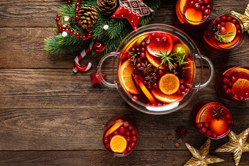 Christmas punch. Festive red cocktail, drink with cranberries and citrus fruits in a punch bowl and...