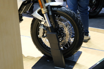 Closeup of new motorbike rear wheel . Big bike parked in showroom of dealership