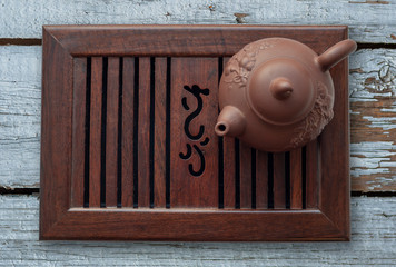 Chinese tea ceremony. ceramic teapot on a tea table in old wooden background. the view from the top