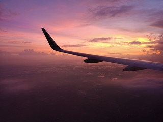 airplane flying over red sky