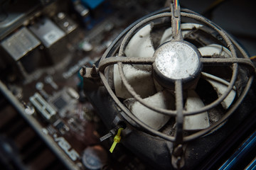 Dust on computer pc processor cooler with mainboard and computer case fragment.