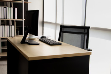 Modern personal computer, keyboard and cup of coffee on desktop in office workspace with window view. Concept of corporate job vacancy, financial world, manager and business.Vintage style