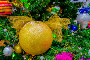 Fototapeta na wymiar Big Golden ball on the Christmas tree. Christmas.Decorations and balls.