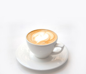 late art on white ceramic coffee cup on white