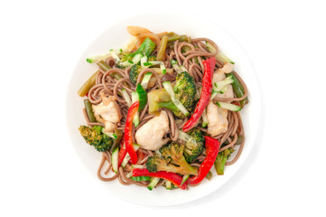 Buckwheat noodles with chicken, onions, green beans, paprika, broccoli, tyriaki sauce, cucumber. On a white plate. View from above. White background. Isolate