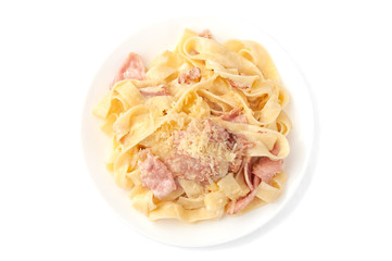 Carbonara paste. With creamy sauce, bacon, ham, parmesan and egg. On a white plate. White background. Isolated.