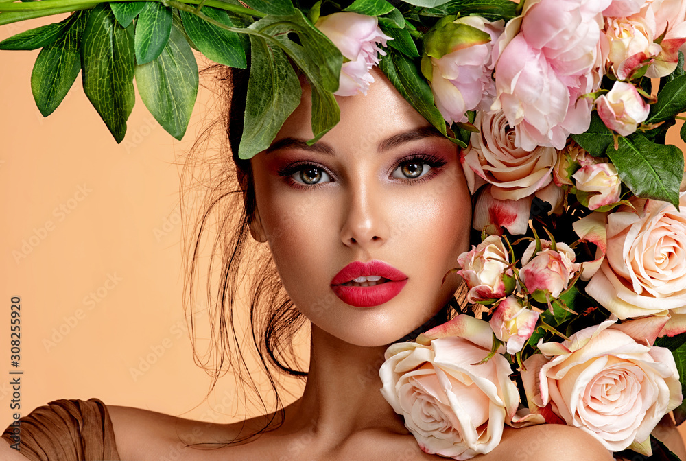 Wall mural beautiful white girl with flowers. stunning brunette girl with big bouquet flowers of roses. closeup