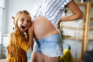 Happy family, togetherness, love. Beautiful pregnant mother with cute child