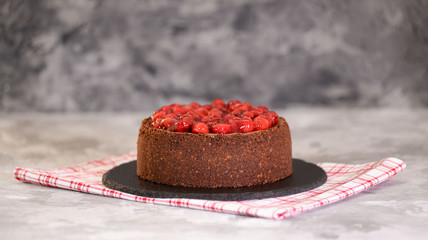Delicious Homemade Chocolate Cheesecake Decorated With Cherry Sauce.