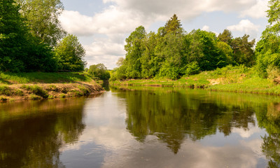 beautiful views of calm water, clouds and tree glare