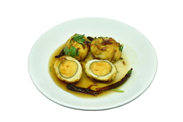 fried egg with tamarind sauce half cut on plate