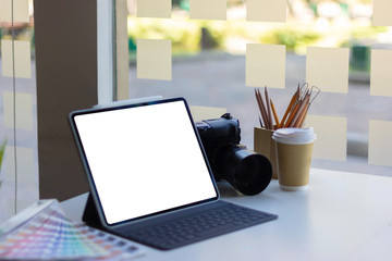 Work space on black table of photographer. Minimal workspace with Laptop, camera and lens copy space on dark background. Modern and elegant. Top view. Flat lay style. Close up.