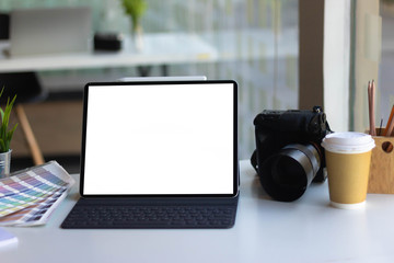 Work space on black table of photographer. Minimal workspace with Laptop, camera and lens copy space on dark background. Modern and elegant. Top view. Flat lay style. Close up.