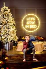 boy in front of christmas tree