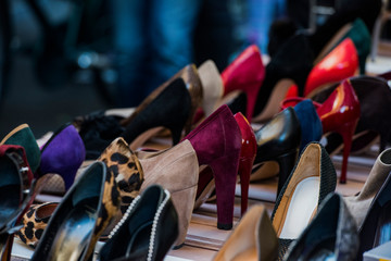 Fototapeta na wymiar Different shoes in a market in Milan