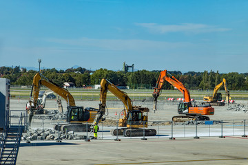 The reconstruction of international airport. A group of construction machines with pneumatic...